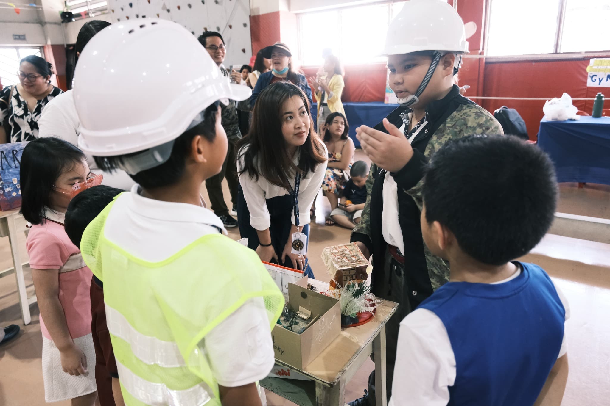 Students at Leaders explaining a hands-on project to younger learners.