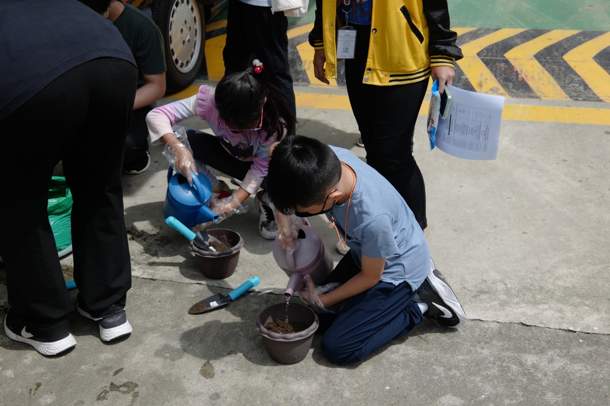Students at Leaders planting seedlings during a hands-on learning activity.